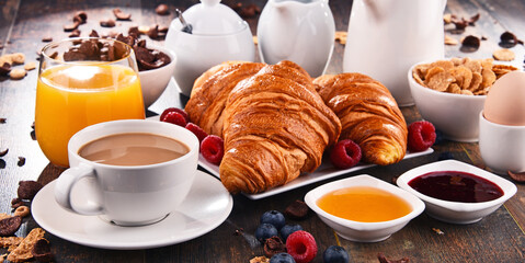 Breakfast served with coffee, juice, croissants and fruits