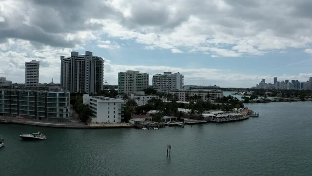 Luxury yachts and highrise building surround the calm waters near Miami Florida, aerial panorama