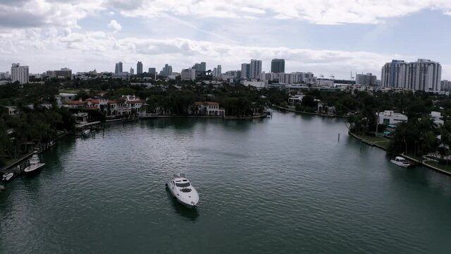 Orbiting around a luxury yacht, Revealing the Miami Florida skyline, aerial