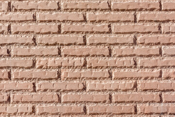 A brick wall of a public building. The masonry is made of red brick.