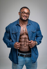 Sexy fitness bodybuilder model in blue shirt. Muscular handsome businessman posing for camera.