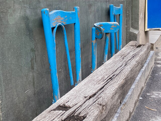 Background of three blue wooden chairs