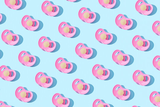 Pink latex baby pacifiers pattern with shadows.