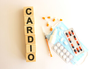 The word CARDIO is made of wooden cubes on a white background. Medical concept.