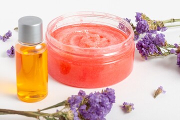 Obraz na płótnie Canvas Jar of cosmetic face scrub with flowers and essential oils. Organic cosmetics, Cosmetics own hands. Spa salon, skin care