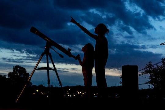 Two Young Girls with telescope for Science Learning