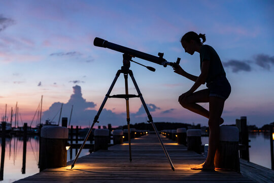 Landscape image of young aspiring Scientist with Telescope