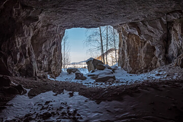 Exit from a mountain cave in winter