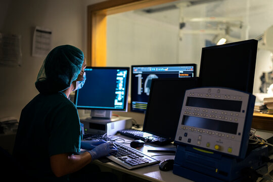Back View of Faceless Doctor Using Computer