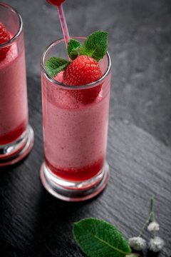 Raspberry Mousse With Syrup And Fresh Raspberries On Top In Glass Jars On A Stone Background. Berry Dessert With Whipped Cream