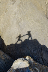Shadow of two people on rock mountain