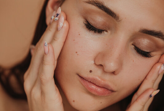 Closeup attractive woman massaging her face