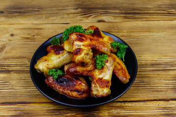 Baked chicken wings on a wooden table