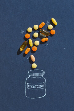 Composition with different pills on color background