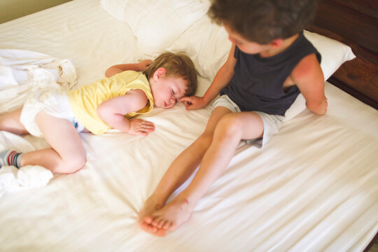 Little brothers sleep in the same bed.