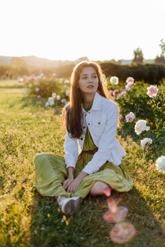 Young woman relaxing on green lawn in park