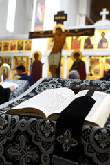 The open religious Orthodox book in the old church language lies in the church before the...