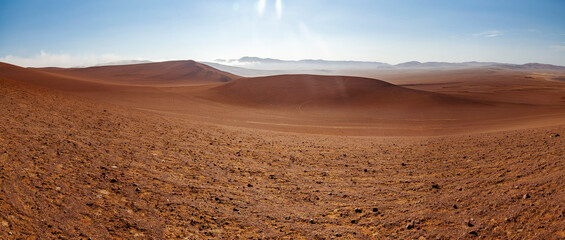 Panoramic stock photography, from the top of the dunes, of the extreme desert landscape of Paracas, near Las Minas Beach, in the Paracas National Reserve, on a sunny and scorching day.