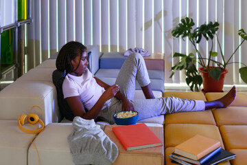 Black student watching film at home