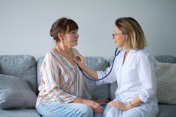 Female professional doctor showing medical test result explaining prescription using digital tablet...