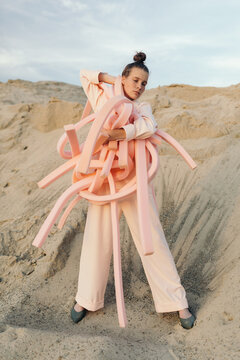 Extravagant female model in sandy terrain