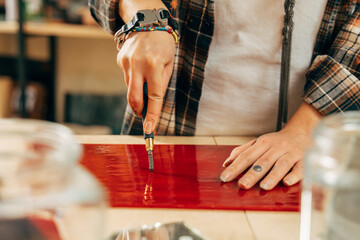 Woman creates a new collection of mosaik, while working with glass