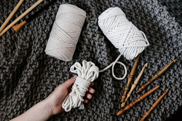 Artisan with crochet supplies and knitted textile