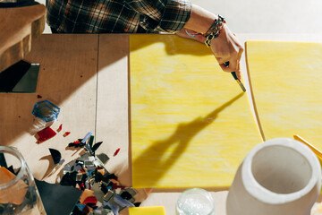 Female artist working with blade at the new mosaics