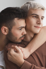 Two Young Men Embracing Close Up