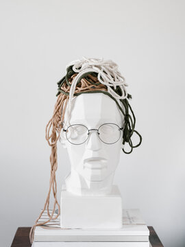 Gypsum bust with threads and eyeglasses