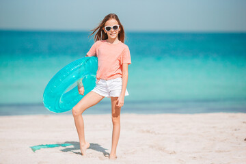 Naklejka na ściany i meble Adorable little girl have fun at tropical beach during vacation