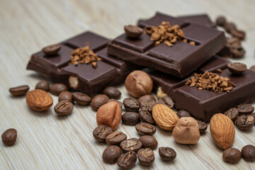 Chocolate pieces with nuts and chocolate chips. Image of a chocolate composition for placement in a cafe.