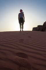 Silhouette of woman on a desert dune