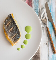 Steam bream sided by dots of Dutch green sauce