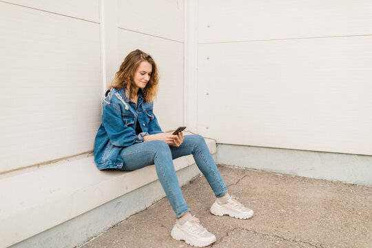 young woman sitting outdoors