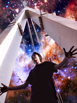 Surrealistic collage. The boy on the bridge looks at the starry sky
