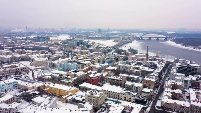 Aerial view of the Podil area, St. Andrew's Church, Kontraktova Square and Kiev. Old residential buildings overlooking the city.