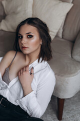 Obraz premium Portrait of young beauty brunette woman with stylish haircut indoors. Sexy, sensual, fashionable, caucasian girl