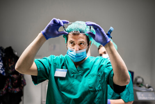 Male Doctor Taking Off his Medical Safety Glasses