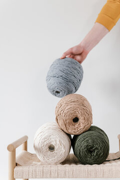 Needlewoman with stack of colorful threads