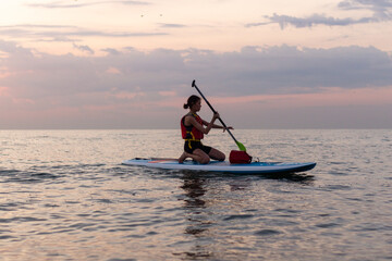 Kayaking Woman in kayak. Girl Rowing in the water of a calm sea