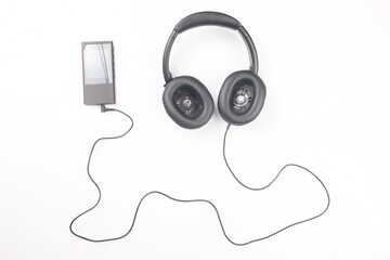 Headphones for listening to music with digital audio player on white background