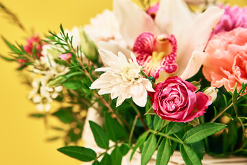 Bunch of fresh summer flowers on the yellow background
