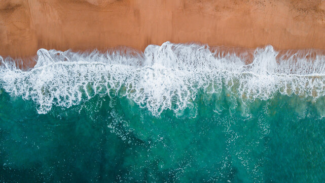 Aerial shot of the ocean shore and waves