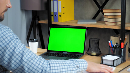 Green screen mock up chroma key display monitor laptop computer concept: Businessman at home office listen company top manager employee online remote conference webcam video call business meeting chat