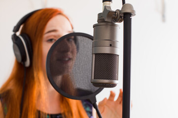 The girl sings at home using professional equipment