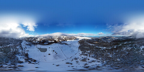 360 degree drone shooting of the Biviere lake in the heart of the Nebrodi mountains in winter. View of Etna and the Aeolian Islands. Sicily in winter. Sicilian mountains.