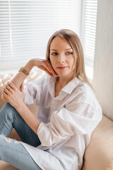 Woman indoor portrait. Young beautiful girl at home