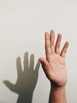 hand touching his shadow