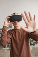 Young Man Playing VR and Reaching Out